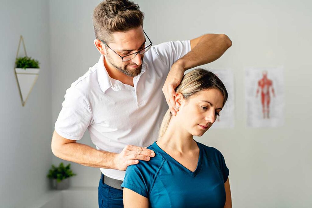 Person sitting comfortably after a chiropractic adjustment with a warm compress on the lower back.